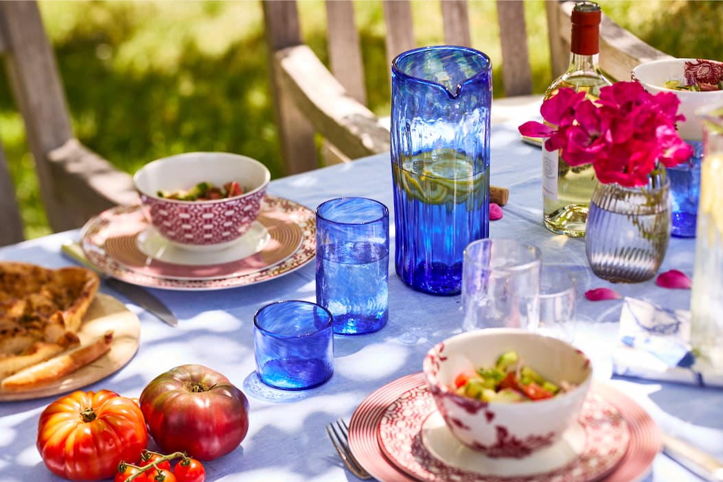 Table filled with cobalt and clear Viento Glassware