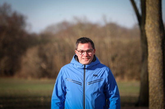 an image of a person standing in front of a group of pigs