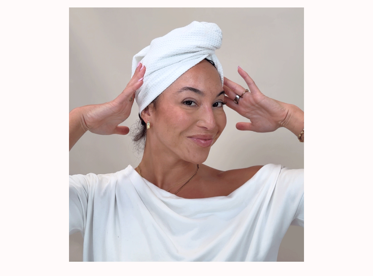 Woman applying product to hair and wrapping hair in a towel 
