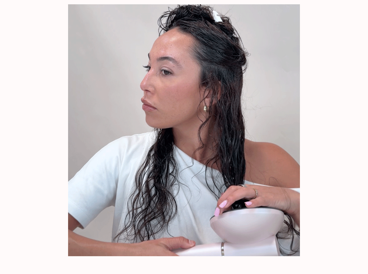woman using diffuser tool on curly hair