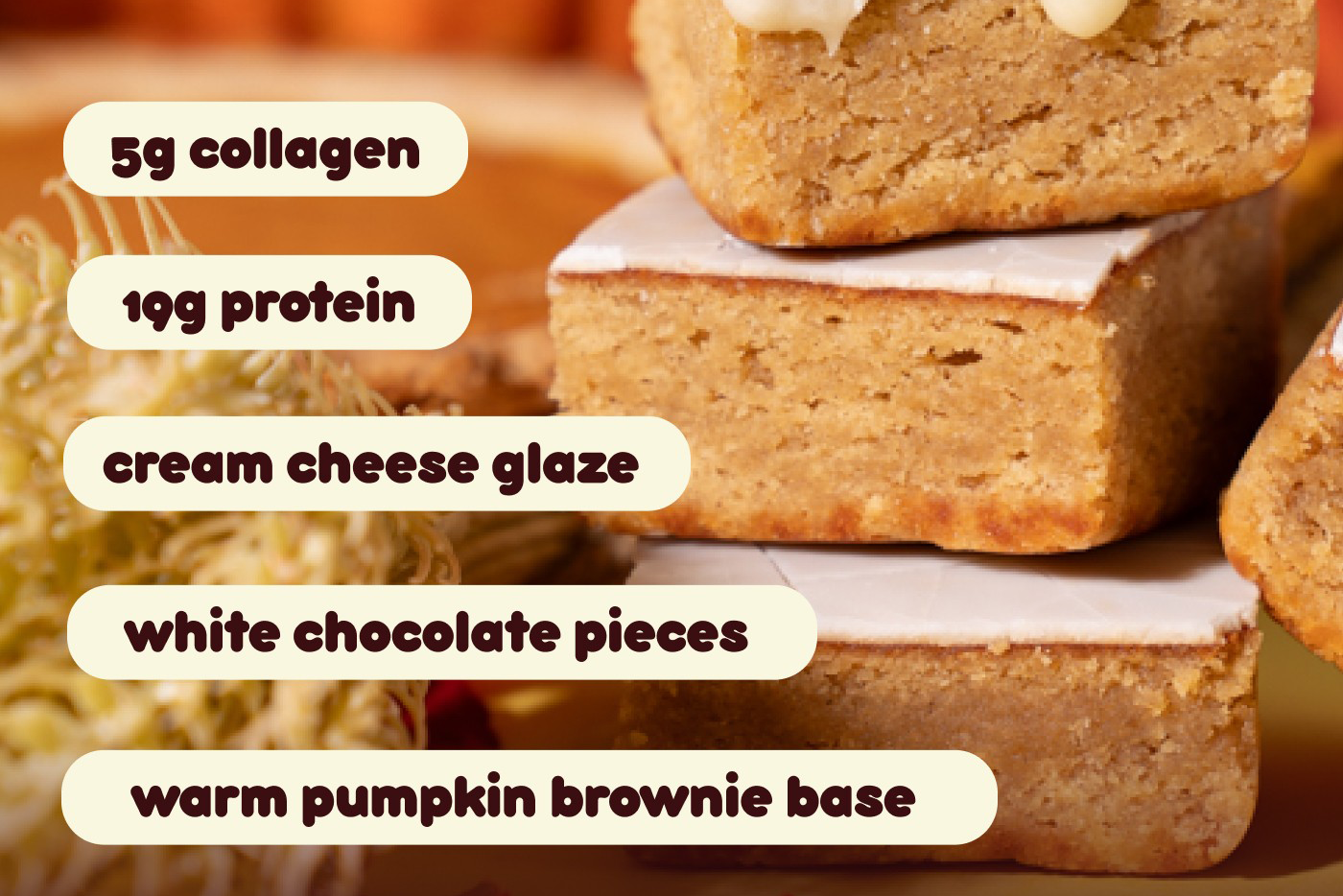 5g collagen. 19g protein. cream cheese glaze. white chocolate pieces. warm pumpkin brownie base.