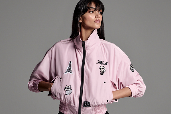 an image of a woman in a pink jacket and black pants