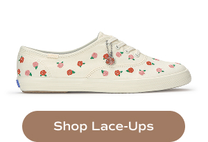 A profile view of the Keds Champion Canvas Rose Embroidery Lace-Up in cream/red. Shop Lace-Ups.