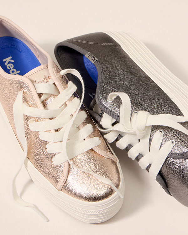 A pair of Triple Up Metallic Leather Platform Lace-Ups, one in gold and the other in gunmetal.