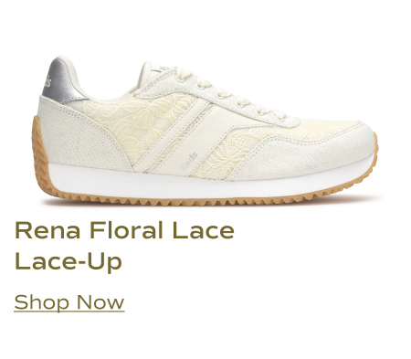 A side view of the Keds Rena Floral Lace lace-up sneaker in egret / cream. It features a delicate floral lace overlay on the upper, with a white Keds logo tag on the side, a metallic silver accent on the heel, and a brown rubber outsole. Shop Now.