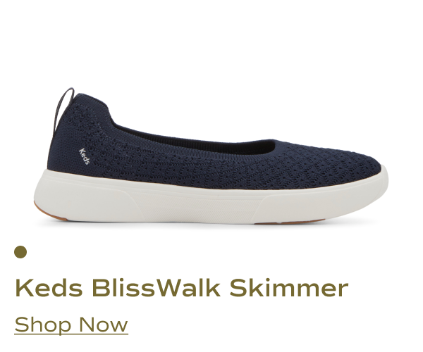A side view of the Keds BlissWalk Skimmer Starburst slip-on shoe in dark navy blue. Shop Now.