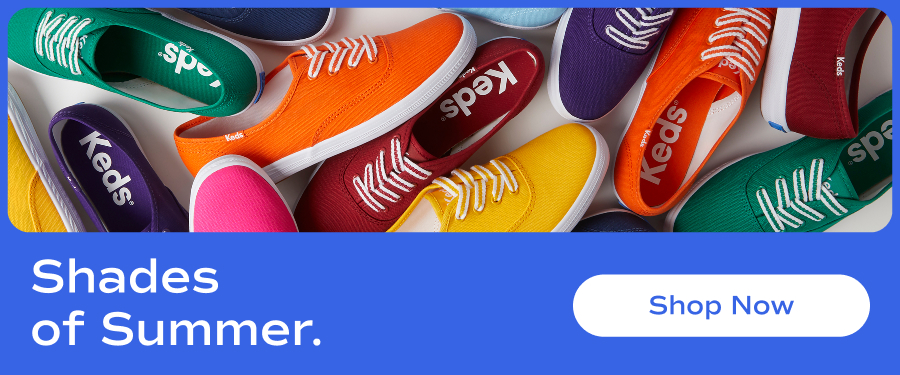 A vibrant flat lay of Keds Champion Canvas lace-up sneakers in an array of bold colors, including red, yellow, green, blue, purple, and orange. The shoes are arranged in an overlapping pattern, creating a lively and energetic composition. Text underneath says Shades of Summer. Shop Now.