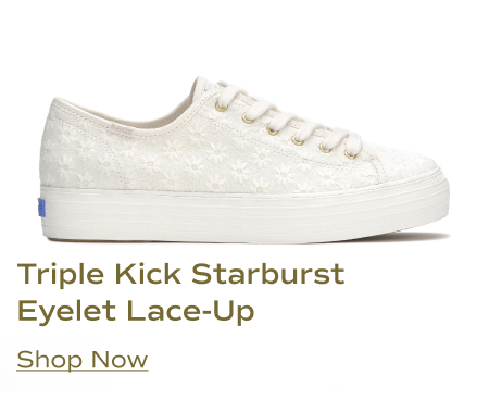 A side view of the Keds Triple Kick Starburst Eyelet Lace-Up sneaker in snow white. It features an all-over daisy eyelet pattern on the upper, white laces with gold eyelets, and a platform sole. Shop Now.