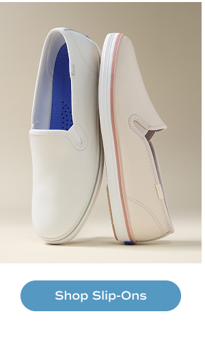 The Keds Champion Leather Foxing Stripe Slip-On in off-white and blush. Shop Slip-Ons.