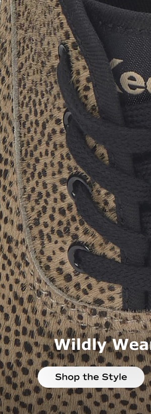 A zoomed-in view of the top of the Keds Champion Calf Hair Lace-Up in brown/black cheetah print showcasing the black cotton laces and calf hair texture. Shop the style.