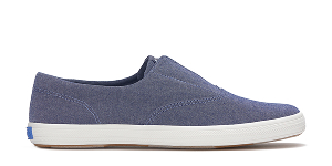 A side view of the Keds Champion Round Toe Chambray Slip-On in navy.