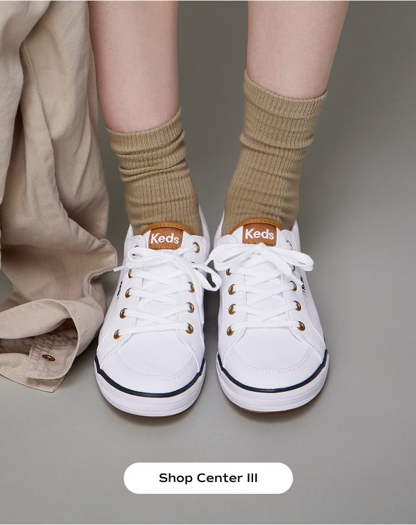 The Center III Canvas Lace-Up in white/blue worn with slouchy tan socks. Shop the Center III.