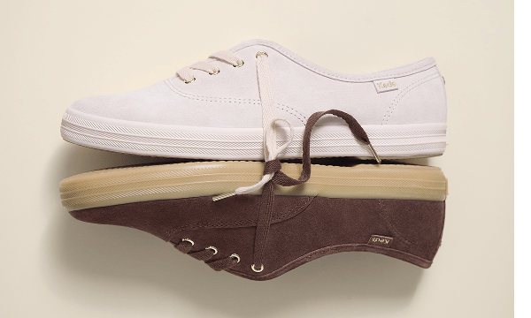 The Keds Champion Luxe Suede Lace-Up in blush touching the sole of the Keds Champion Luxe Suede Lace-Up in chocolate.