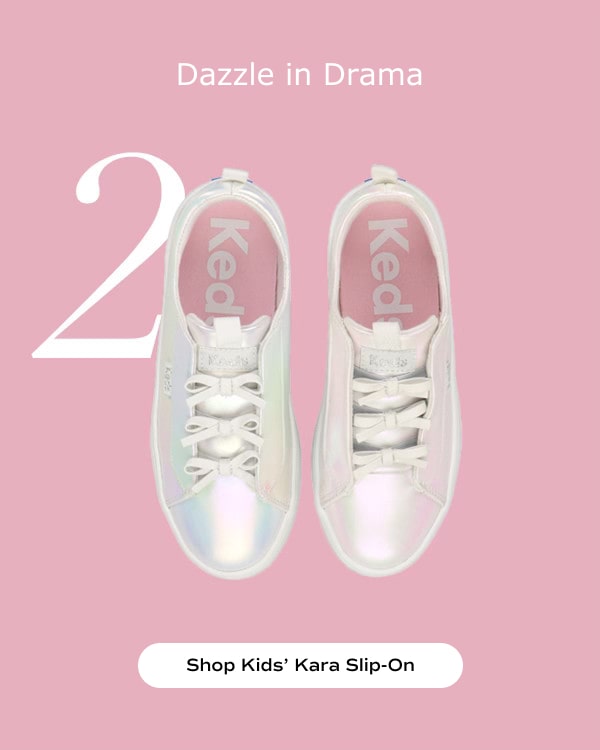 Dazzle in Drama. A top-down view of a pair of big kids' Kara Slip-Ons with Bows in iridescent. Shop Now.