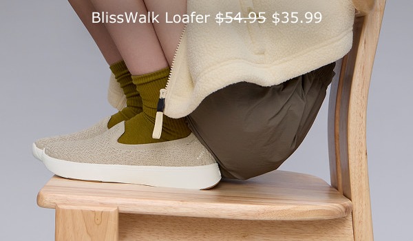A woman sitting in a chair wearing brown shorts, olive socks, and the BlissWalk Knit Loafer in taupe. The BlissWalk Loafer was $54.95 and is $35.99 with code LONGWEEKEND.