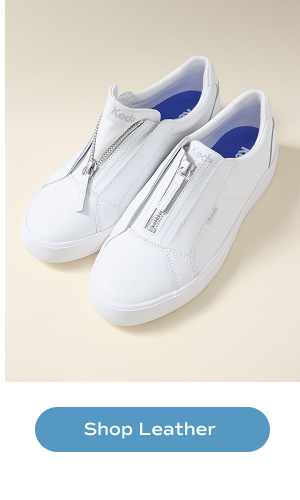 A pair of the Pursuit Zip Leather Sneakers in white. Shop Leather.
