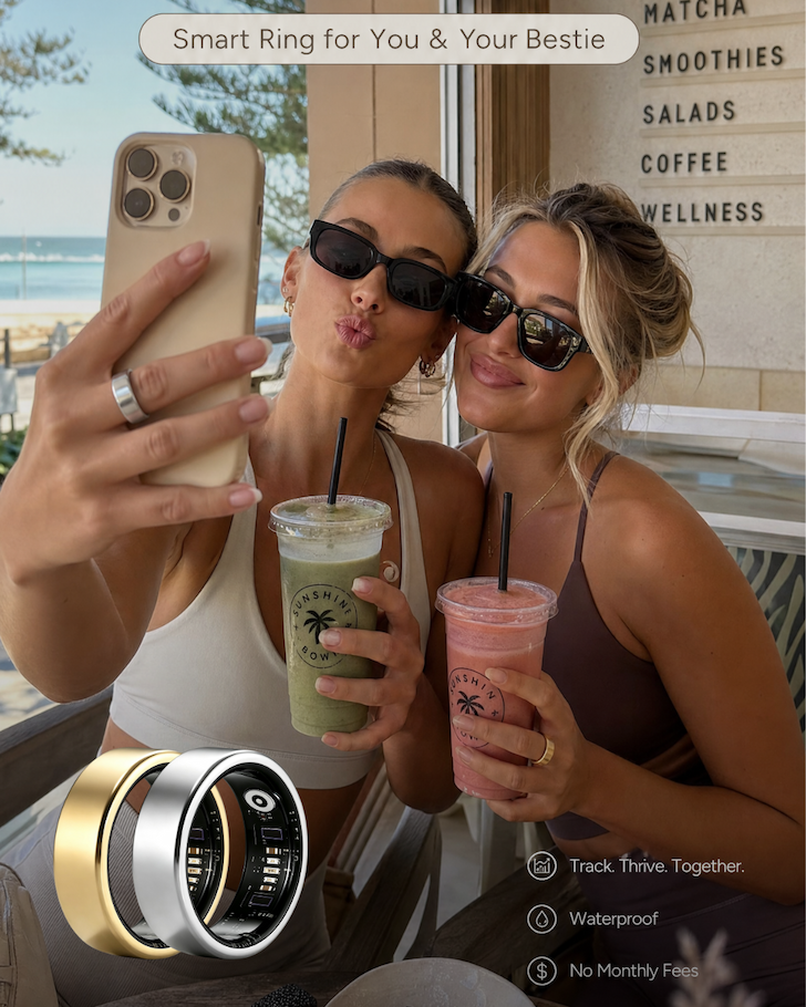 Two best friends taking a selfie at a beachside cafe, with gold and silver ALYN smart rings