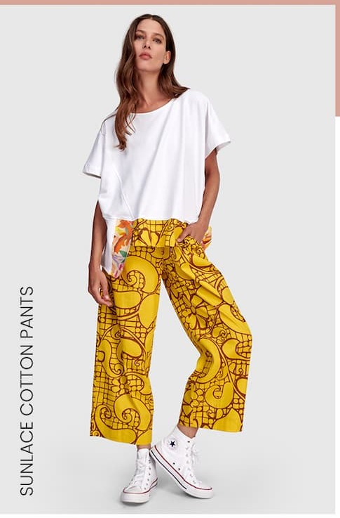 an image of a woman in a white shirt and yellow pants