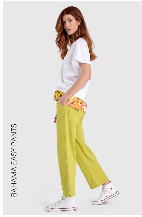 an image of a woman in a white shirt and yellow pants