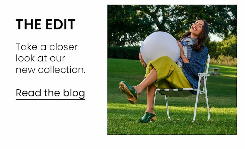an image of a woman in a dress and sandals standing in front of a bouquet of flowers