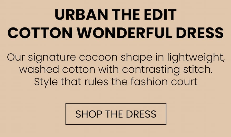 an image of a woman in a dress and sandals standing in front of a bouquet of flowers