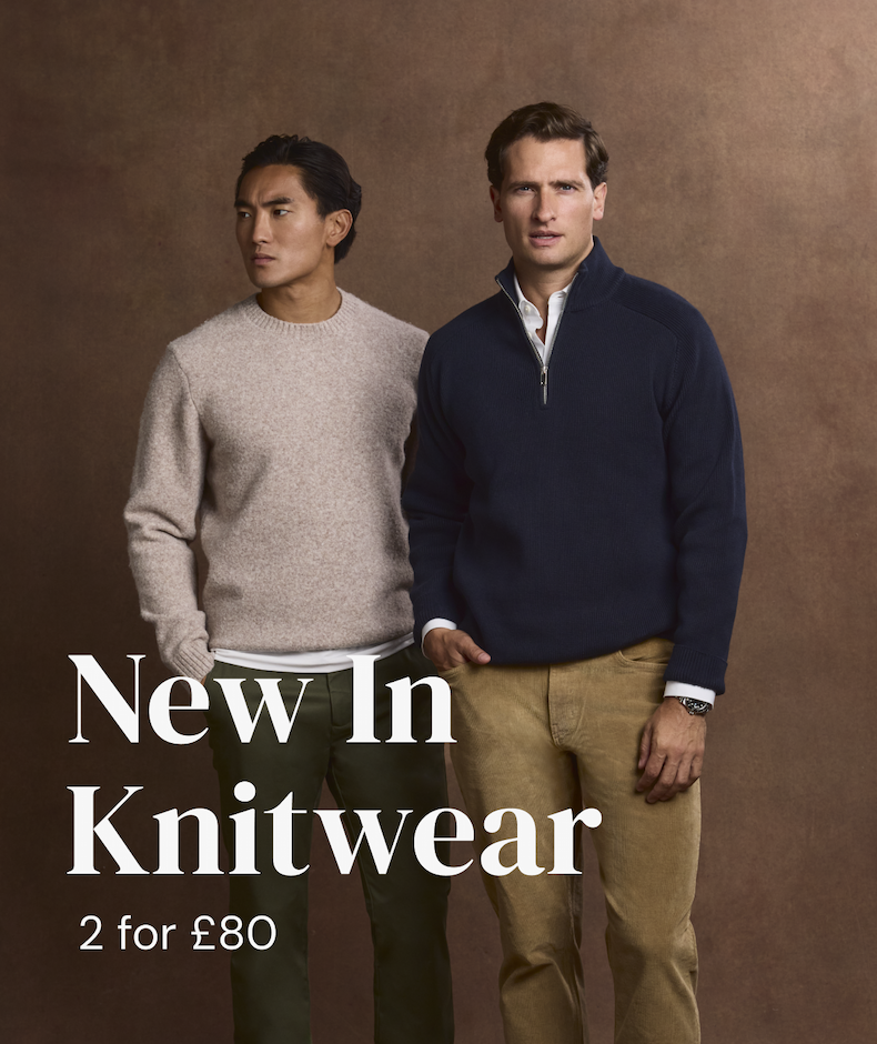 two men in knitwear and trousers
