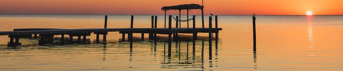 Peaceful dock at sunset over calm water