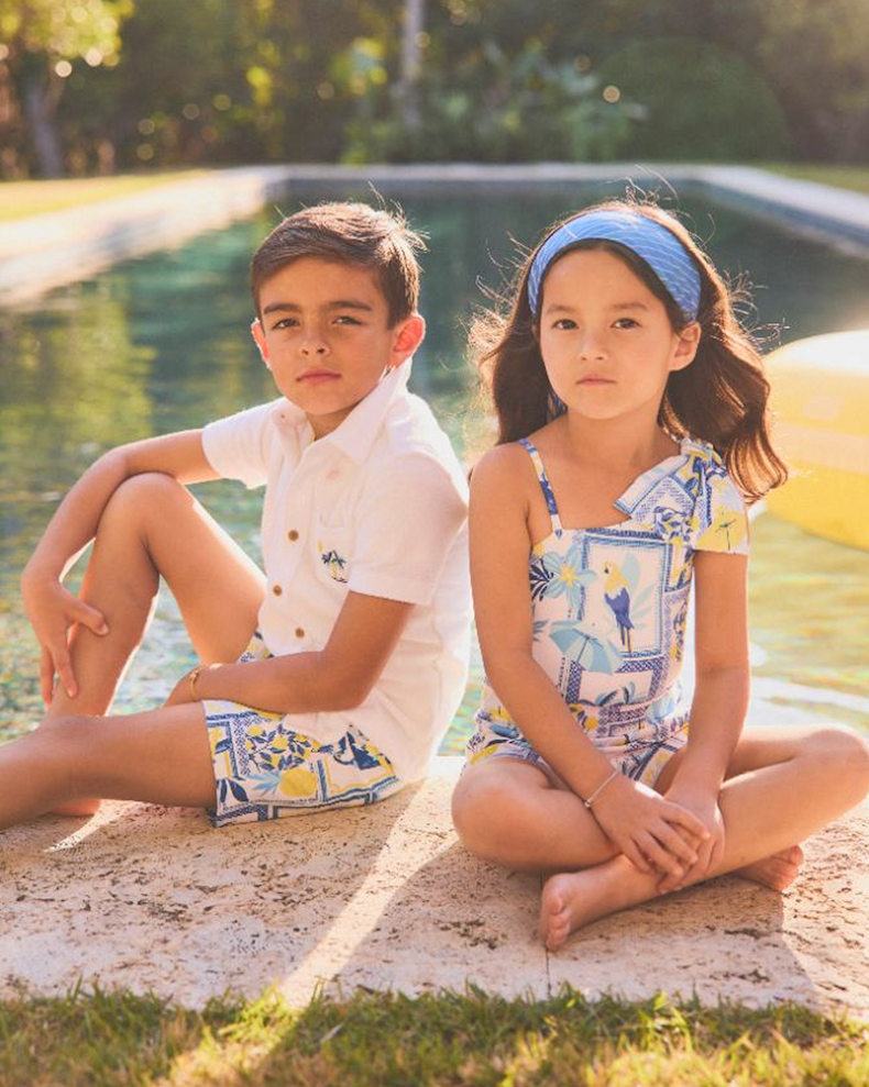 GIRL AND BOY IN BLUE AND YELLOW PRINT BATHING SUIT AND LOUNGEWEAR.