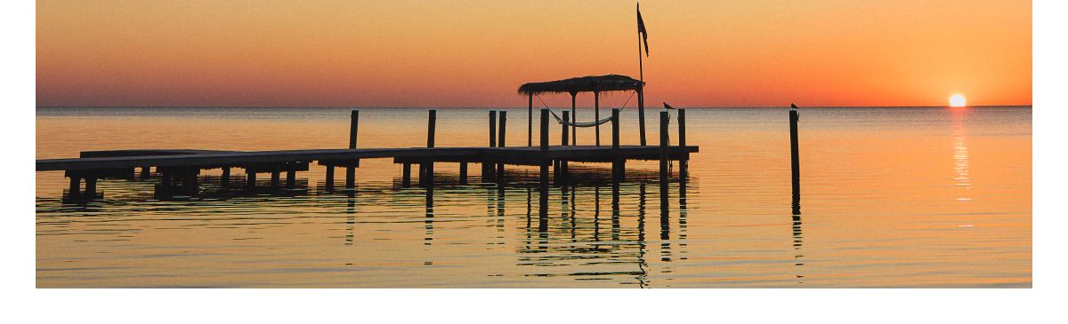 Peaceful dock at sunset over calm water