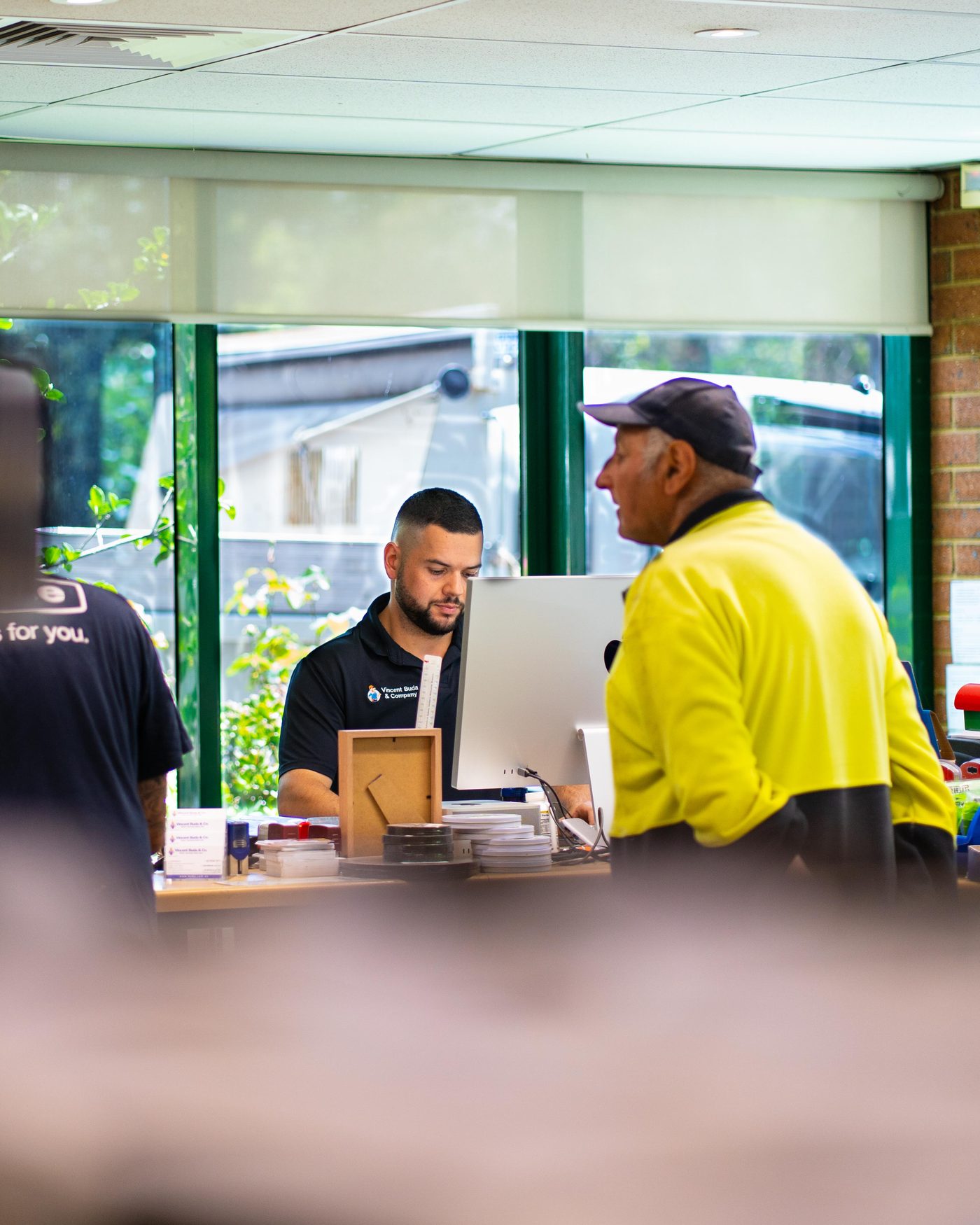 A Vincent Buda and Co staff member processing an order at the trade counter