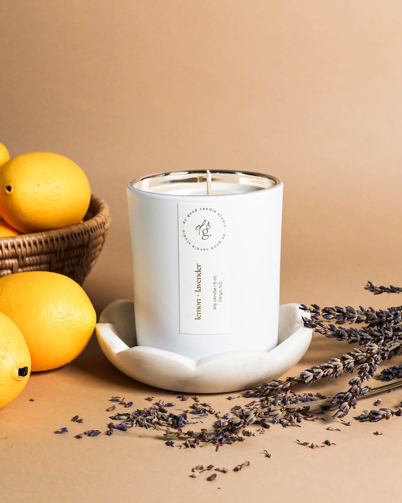 image of lemon + lavender candle styled with lemons and lavender springs