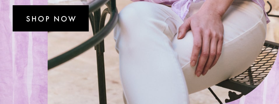 Woman wearing a pink striped blouse and white pants