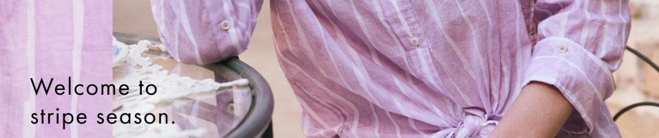Woman wearing a pink striped blouse and white pants