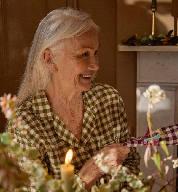 Lady Smiling at Christmas Table