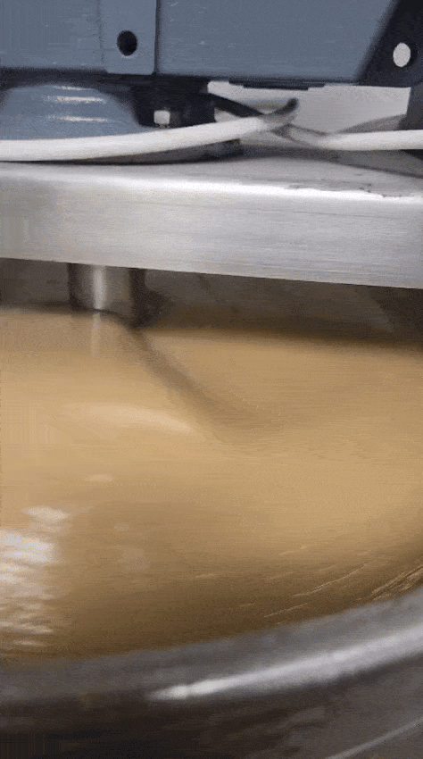 Creamed honey being stirred in our large creamer