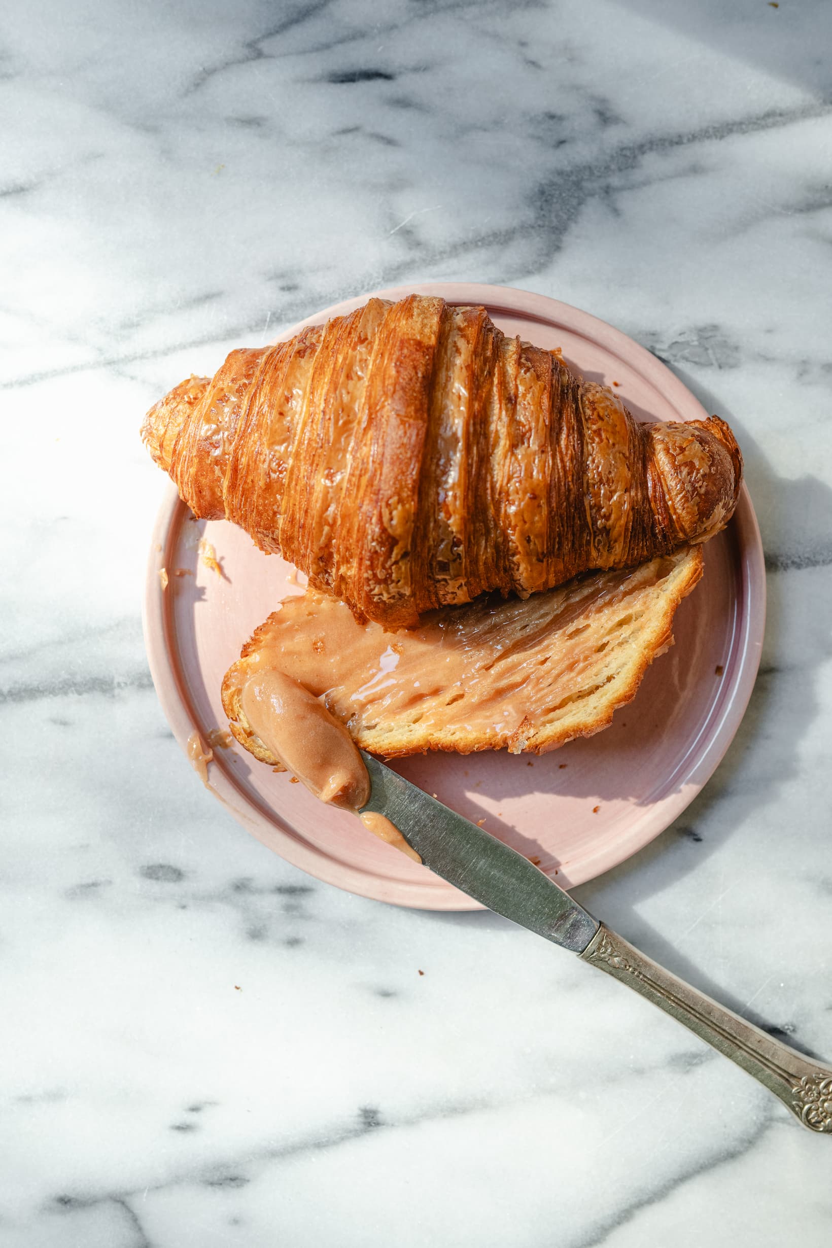 Enjoying our Strawberry Honey on a fresh croissant.