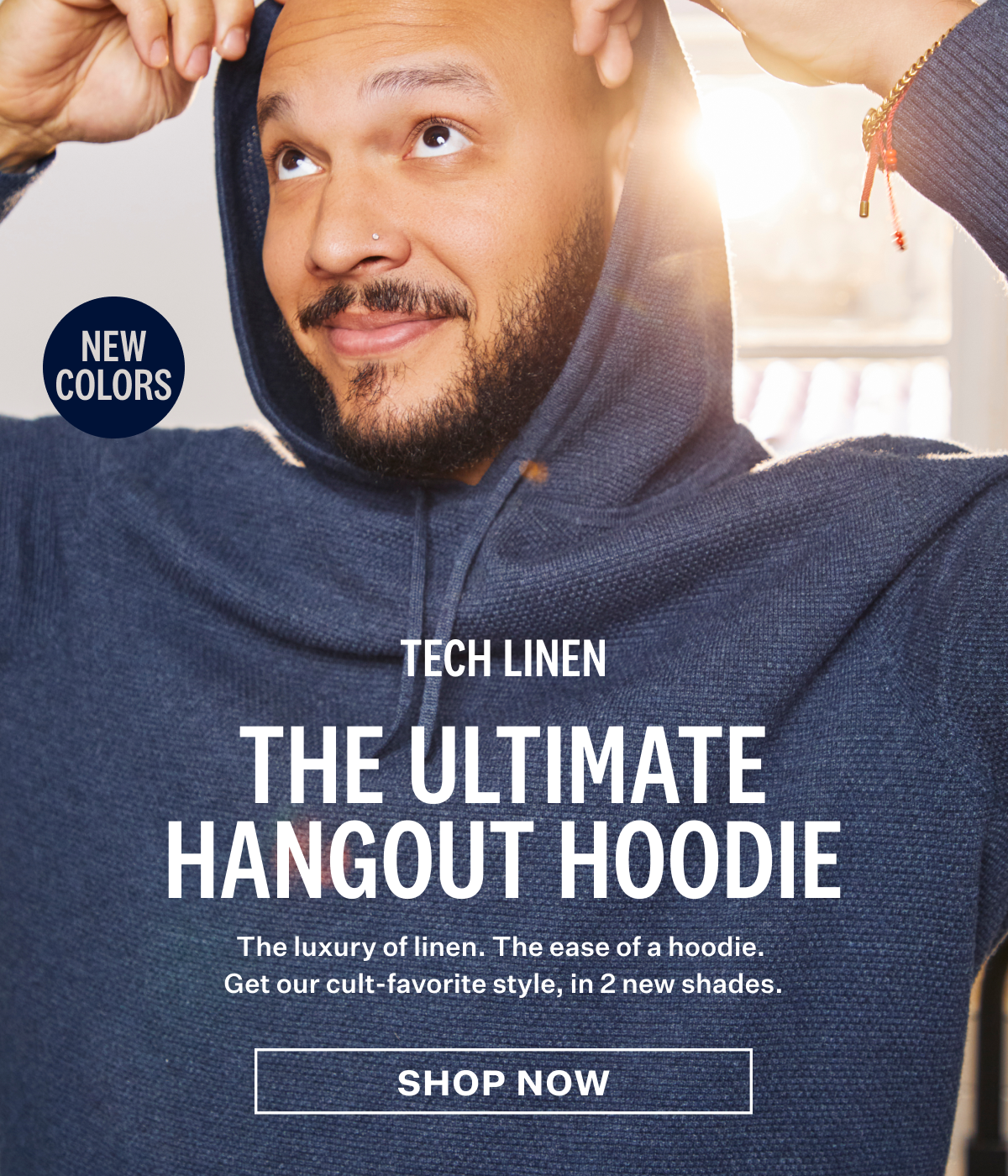 A man wearing Tech Linen Hoodie in new color Navy Heather.