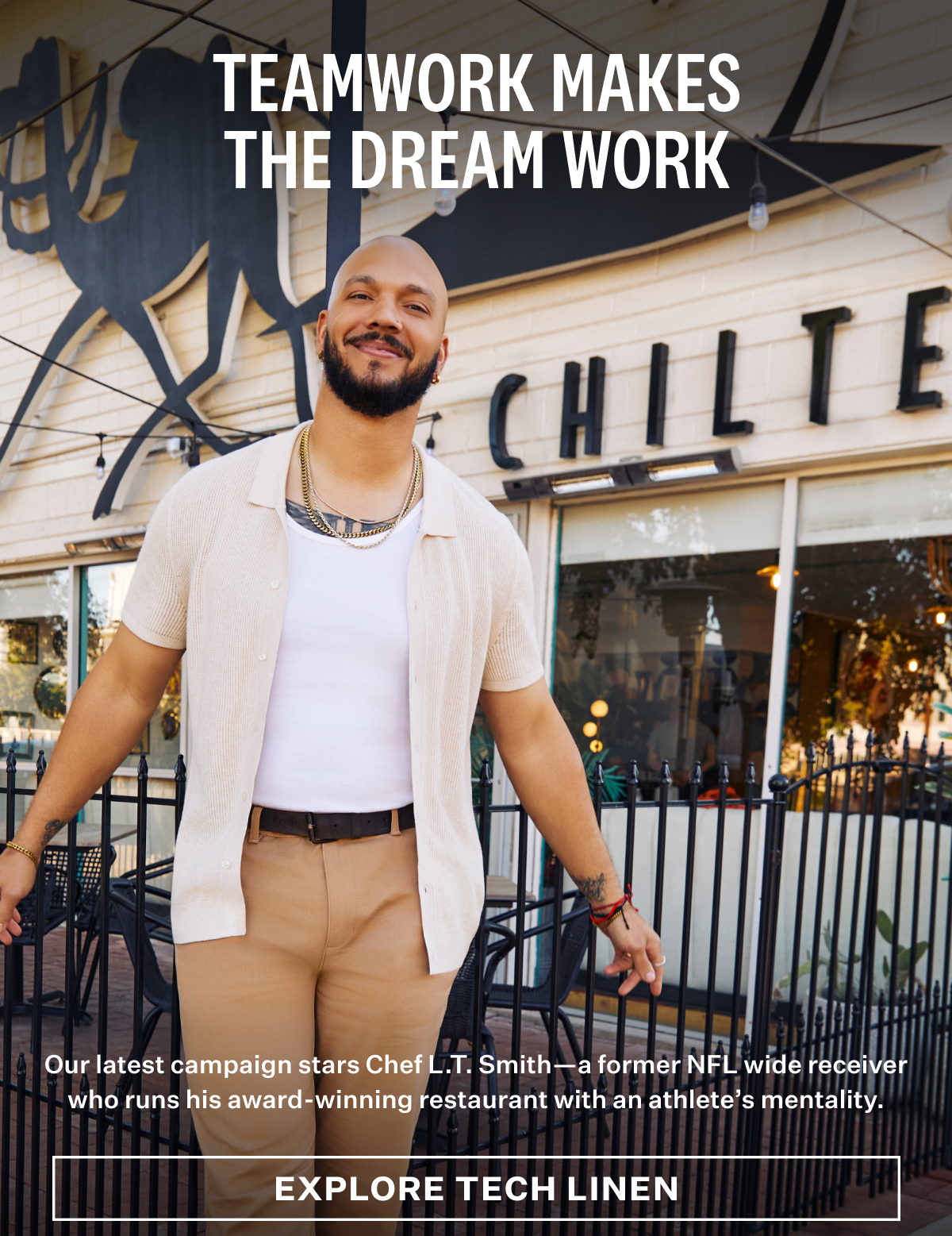 Chef L.T. Smith smiling in front of his restaurant, wearing a Tech Linen Button Up Sweater Polo