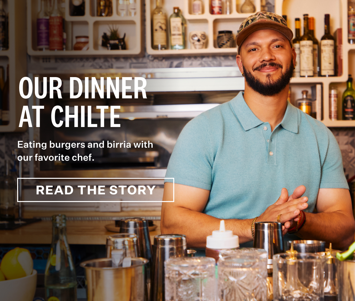 Chef L.T. Smith standing behind a bar, wearing a Tech Linen Sweater Polo