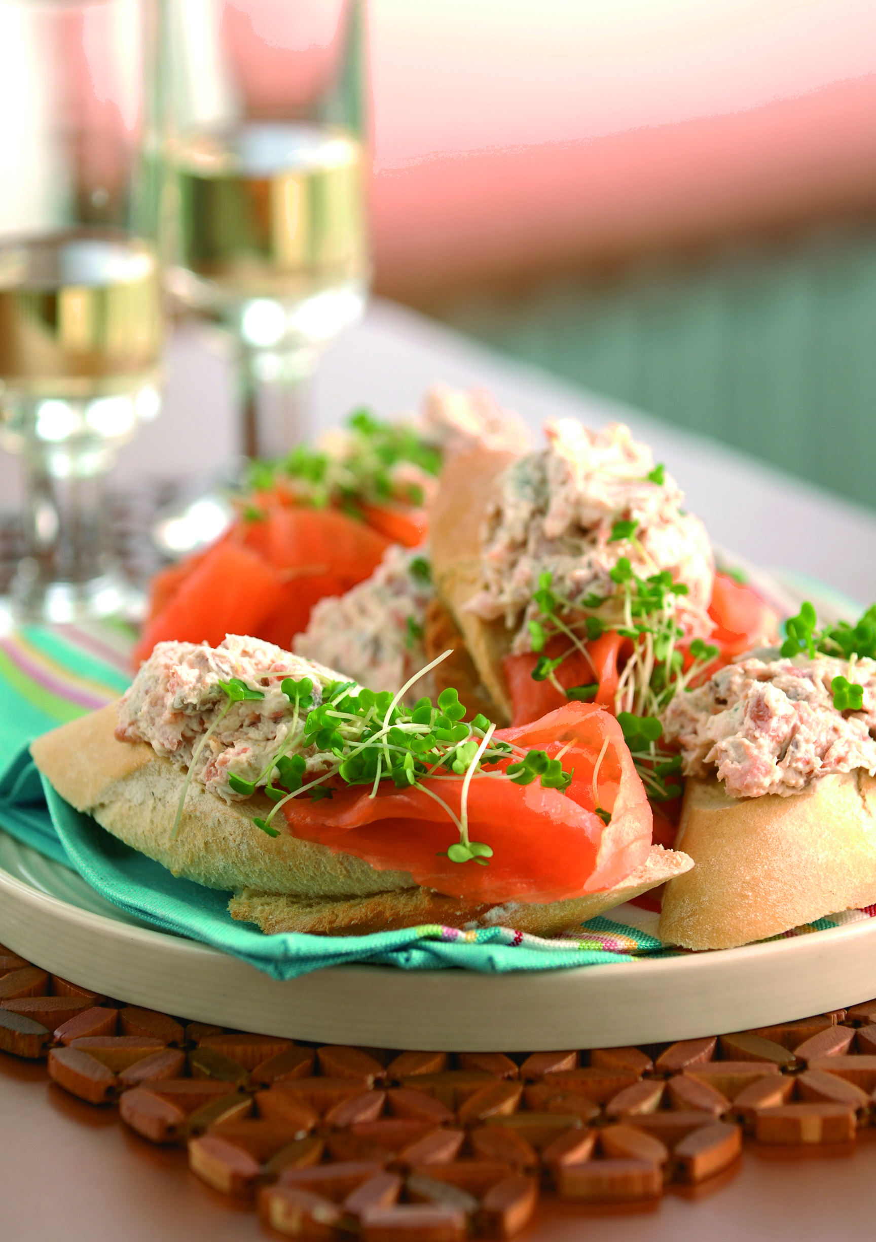 Salmon and pâté piled onto crisp toasts with fresh green garnish