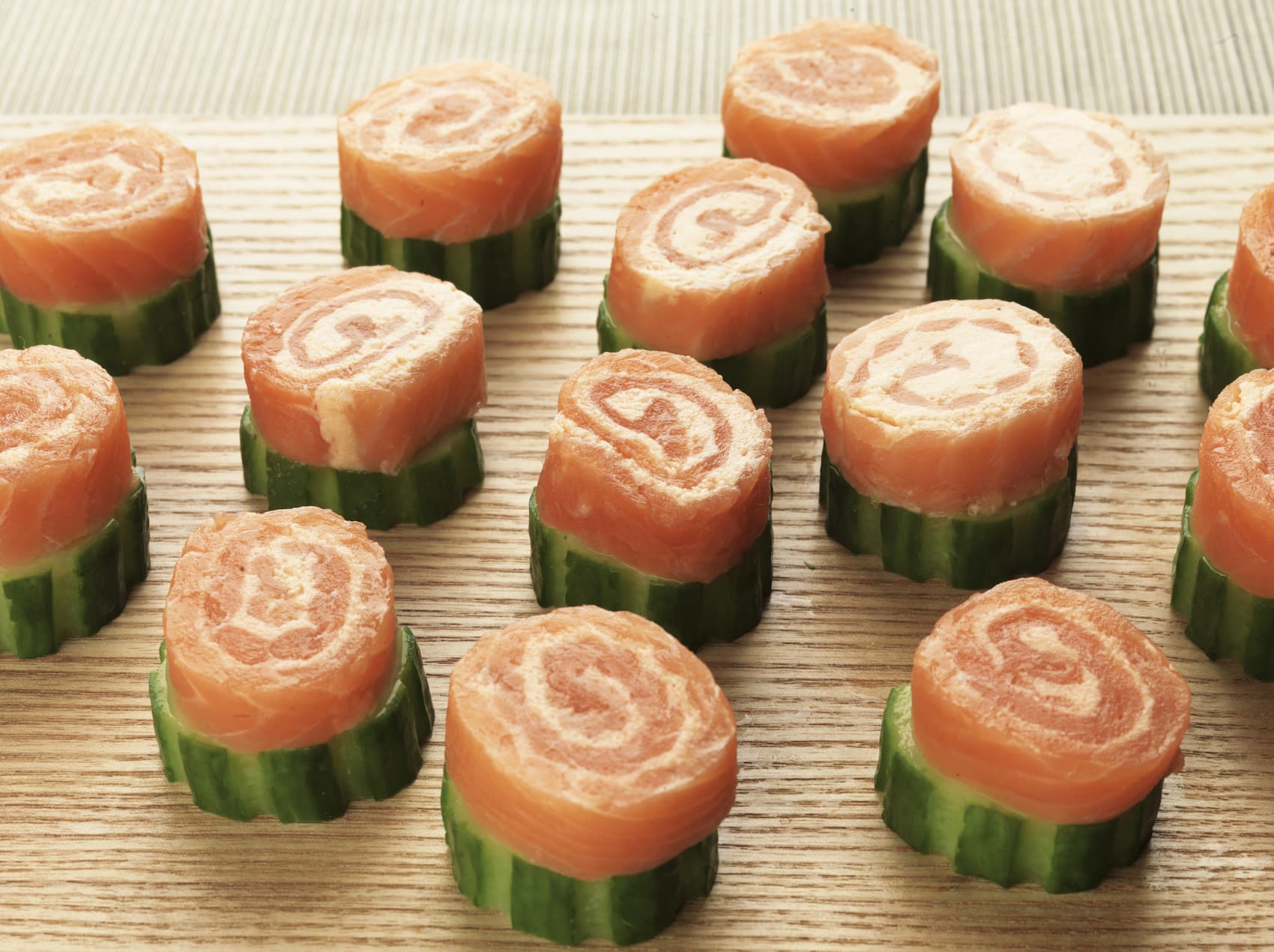 Sliced salmon Catherine wheels served on cucumber rounds