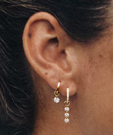 New lab grown diamond drilled stone charms styled on ear.