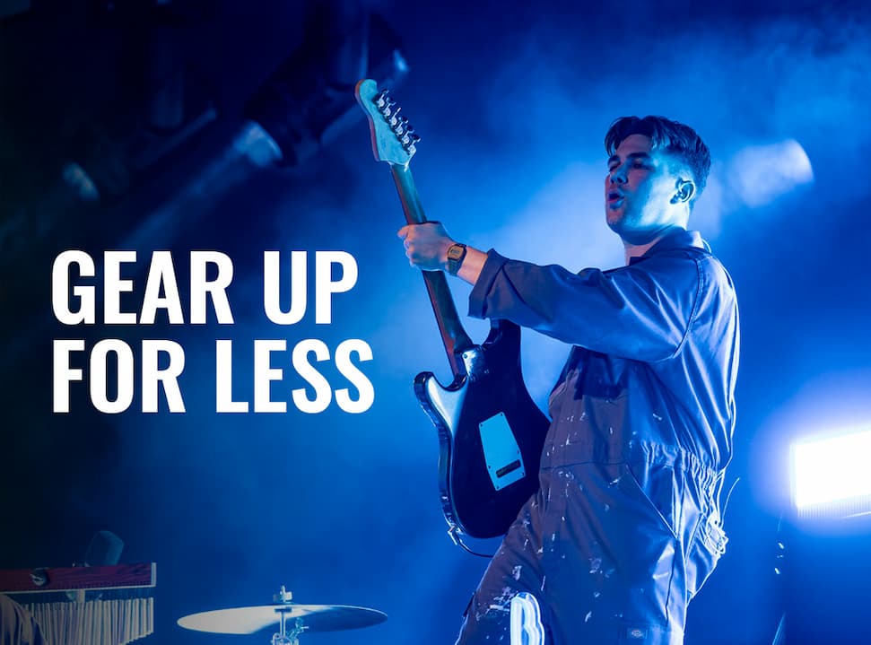 an image of a man playing a guitar on stage with a crowd