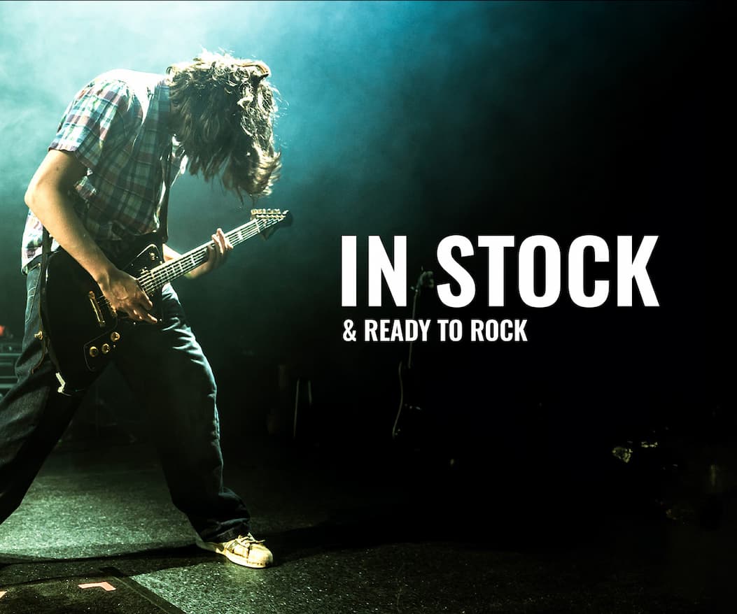 Guy playing a Baum Wingman guitar on stage