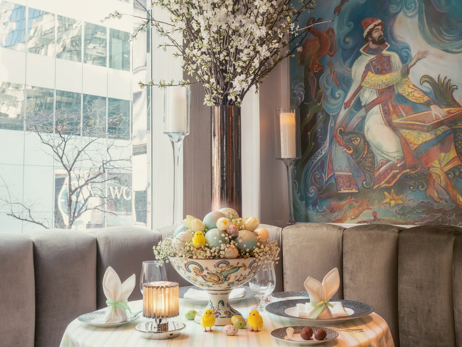 an image of a table with a bowl of fruit and a vase of flowers