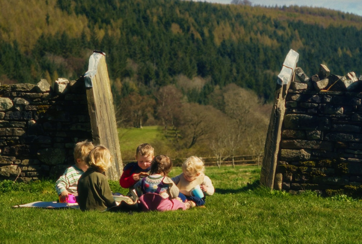 The children sat with mountainous background