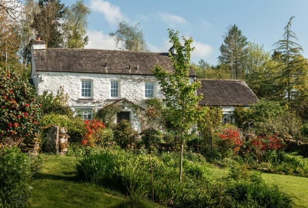 The exterior of The Tapestry in The Lake District; a countryside farmhouse