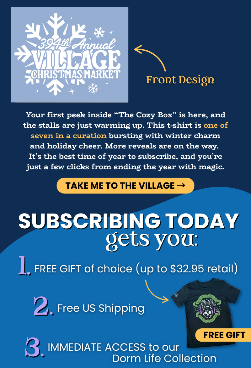 Close-up of the Village Christmas Market Tee design showing snowflakes and text '394th Annual Village Christmas Market.' Accompanying copy introduces The Cozy Box and describes it as one of seven winter treasures filled with holiday charm. Yellow button reads 'Take Me to the Village.' Below, list of subscriber perks: 1. Free gift of choice (up to $32.95 retail). 2. Free US shipping. 3. Immediate access to the Dorm Life Collection. Includes product photo labeled 'Free Gift.'
