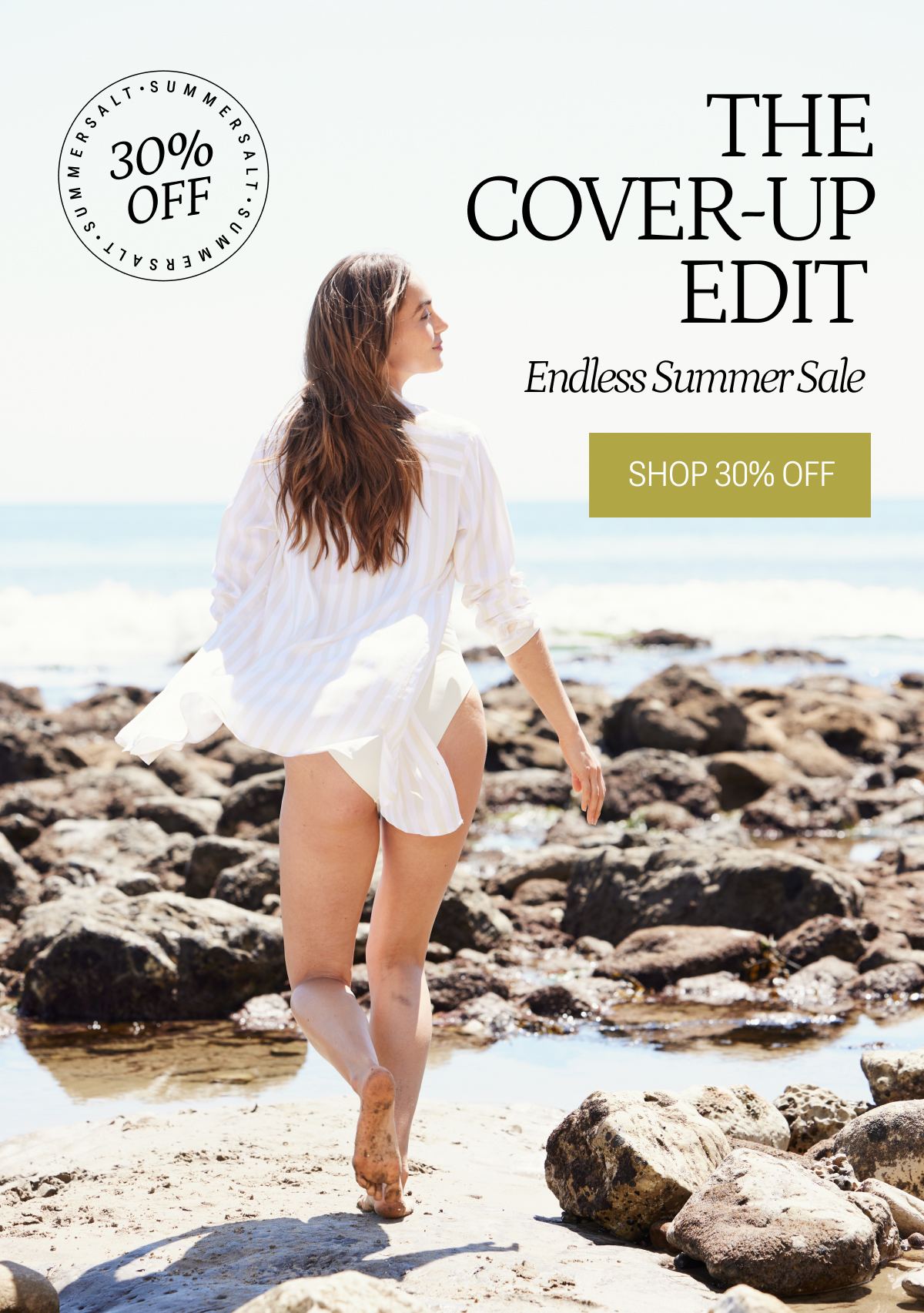 Model wearing white cover up on the beach