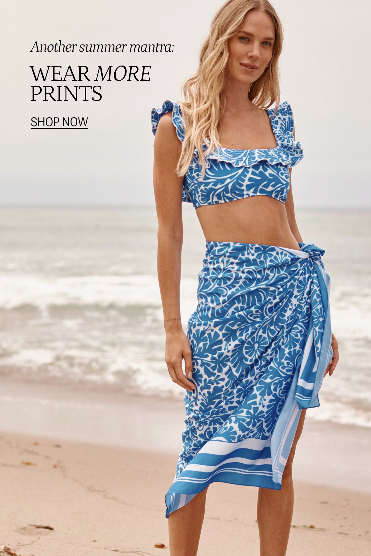 Model wearing a blue floral print one piece swimsuit and matching cover-up